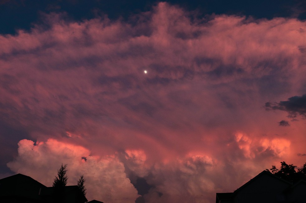 Storm Clouds and Moon At Sunset